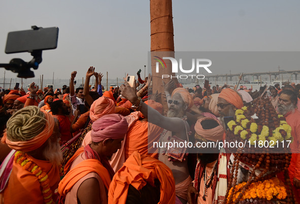 Indian Sadhus (Hindu holy men) gather during the Dharam Dhwaja (religious flag) ceremony at the Sangam area, ahead of the upcoming Maha Kumb...