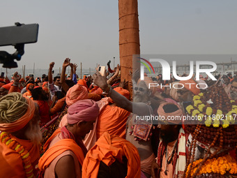 Indian Sadhus (Hindu holy men) gather during the Dharam Dhwaja (religious flag) ceremony at the Sangam area, ahead of the upcoming Maha Kumb...