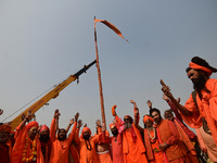 Indian Sadhus (Hindu holy men) gather during the Dharam Dhwaja (religious flag) ceremony at the Sangam area, ahead of the upcoming Maha Kumb...