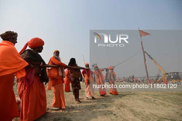 Indian Sadhus (Hindu holy men) gather during the Dharam Dhwaja (religious flag) ceremony at the Sangam area, ahead of the upcoming Maha Kumb...