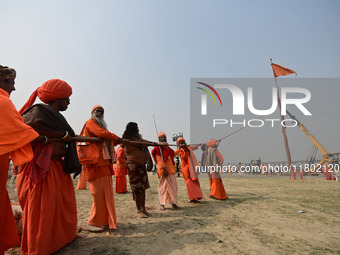 Indian Sadhus (Hindu holy men) gather during the Dharam Dhwaja (religious flag) ceremony at the Sangam area, ahead of the upcoming Maha Kumb...