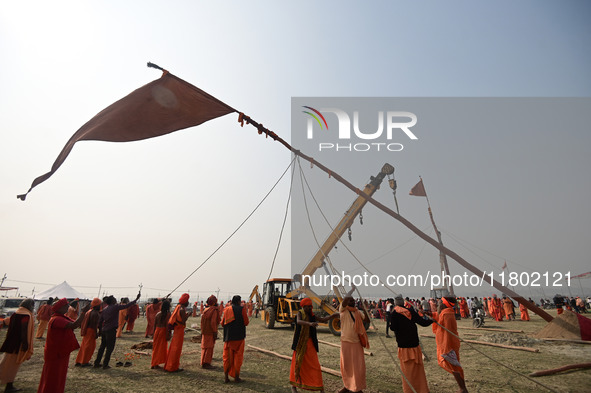 Indian Sadhus (Hindu holy men) gather during the Dharam Dhwaja (religious flag) ceremony at the Sangam area, ahead of the upcoming Maha Kumb...