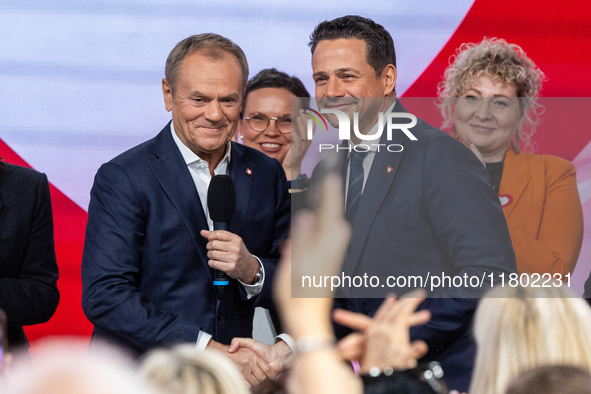 Donald Tusk (L) congratulates Warsaw Mayor Rafal Trzaskowski after the announcement by the National Council of Civic Platform that he is the...