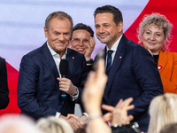 Donald Tusk (L) congratulates Warsaw Mayor Rafal Trzaskowski after the announcement by the National Council of Civic Platform that he is the...