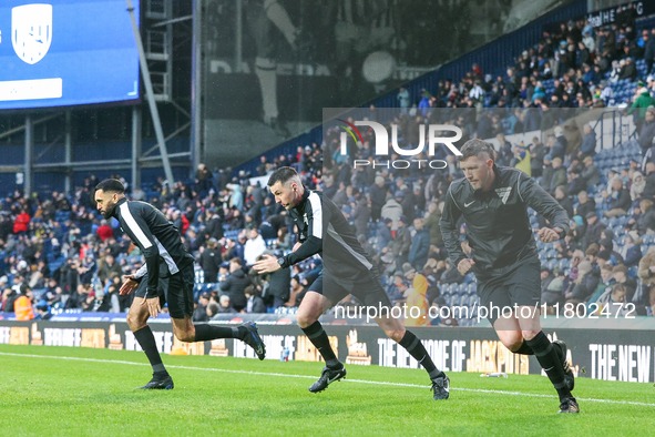 Referee Lewis Smith (center) warms up with his assistants during the Sky Bet Championship match between West Bromwich Albion and Norwich Cit...