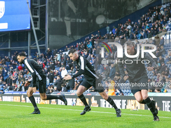 Referee Lewis Smith (center) warms up with his assistants during the Sky Bet Championship match between West Bromwich Albion and Norwich Cit...