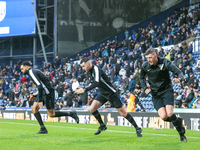 Referee Lewis Smith (center) warms up with his assistants during the Sky Bet Championship match between West Bromwich Albion and Norwich Cit...