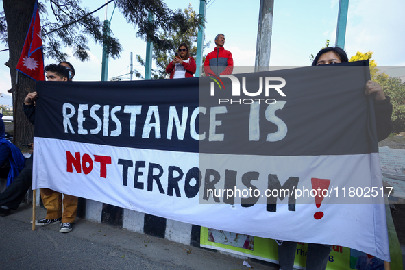 Nepali activists hold banners and placards with slogans demanding an end to Israel's aggression on Palestine during a demonstration in Kathm...