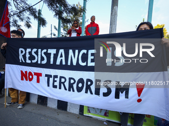 Nepali activists hold banners and placards with slogans demanding an end to Israel's aggression on Palestine during a demonstration in Kathm...