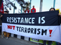 Nepali activists hold banners and placards with slogans demanding an end to Israel's aggression on Palestine during a demonstration in Kathm...