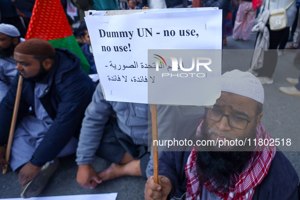 Nepali activists hold banners and placards with slogans demanding an end to Israel's aggression on Palestine during a demonstration in Kathm...