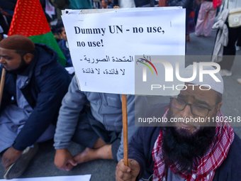 Nepali activists hold banners and placards with slogans demanding an end to Israel's aggression on Palestine during a demonstration in Kathm...