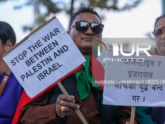 Nepali activists hold banners and placards with slogans demanding an end to Israel's aggression on Palestine during a demonstration in Kathm...