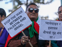 Nepali activists hold banners and placards with slogans demanding an end to Israel's aggression on Palestine during a demonstration in Kathm...