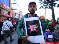 Nepali activists hold banners and placards with slogans demanding an end to Israel's aggression on Palestine during a demonstration in Kathm...