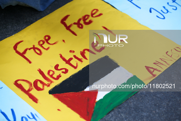 Nepali activists hold banners and placards with slogans demanding an end to Israel's aggression on Palestine during a demonstration in Kathm...