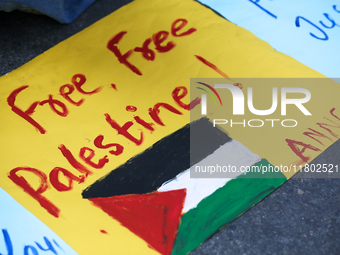 Nepali activists hold banners and placards with slogans demanding an end to Israel's aggression on Palestine during a demonstration in Kathm...