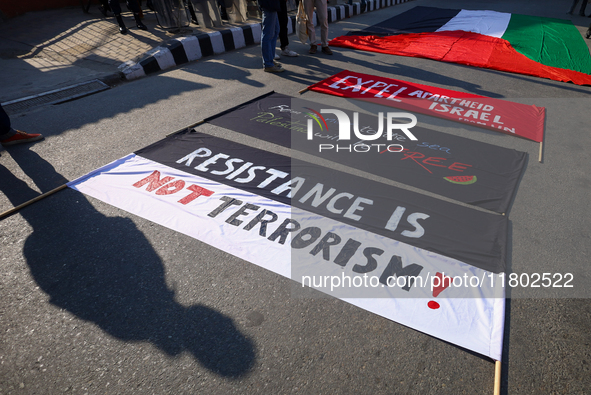 Nepali activists hold banners and placards with slogans demanding an end to Israel's aggression on Palestine during a demonstration in Kathm...