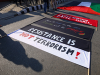 Nepali activists hold banners and placards with slogans demanding an end to Israel's aggression on Palestine during a demonstration in Kathm...