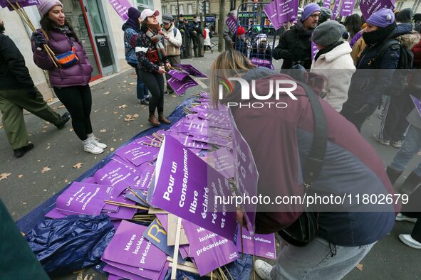 Demonstrators hold placards as they participate in a protest to condemn violence against women, organized by feminist organizations, in Pari...