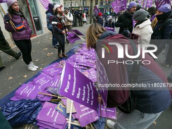 Demonstrators hold placards as they participate in a protest to condemn violence against women, organized by feminist organizations, in Pari...