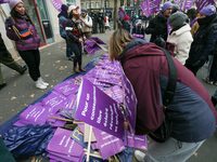 Demonstrators hold placards as they participate in a protest to condemn violence against women, organized by feminist organizations, in Pari...