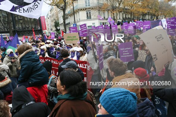 Demonstrators hold placards as they participate in a protest to condemn violence against women, organized by feminist organizations, in Pari...