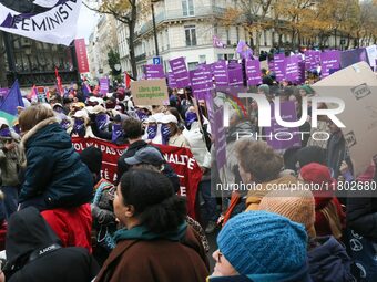 Demonstrators hold placards as they participate in a protest to condemn violence against women, organized by feminist organizations, in Pari...