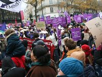 Demonstrators hold placards as they participate in a protest to condemn violence against women, organized by feminist organizations, in Pari...