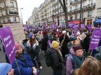 Demonstrators hold placards as they participate in a protest to condemn violence against women, organized by feminist organizations, in Pari...