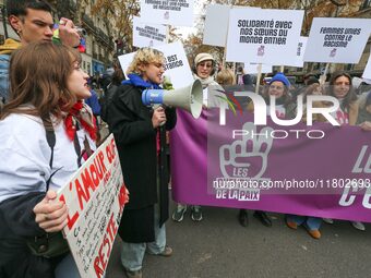 Demonstrators hold a banner as they participate in a protest to condemn violence against women, organized by feminist organizations two days...