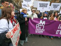 Demonstrators hold a banner as they participate in a protest to condemn violence against women, organized by feminist organizations two days...