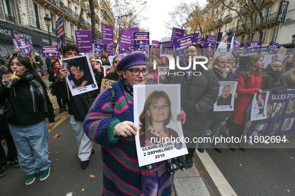 Demonstrators hold placards as they participate in a protest to condemn violence against women, organized by feminist organizations, in Pari...