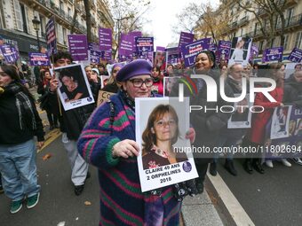 Demonstrators hold placards as they participate in a protest to condemn violence against women, organized by feminist organizations, in Pari...