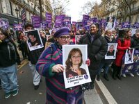 Demonstrators hold placards as they participate in a protest to condemn violence against women, organized by feminist organizations, in Pari...