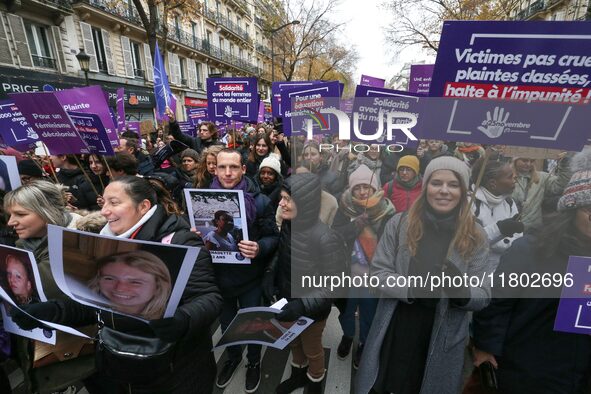 Demonstrators hold placards as they participate in a protest to condemn violence against women, organized by feminist organizations, in Pari...