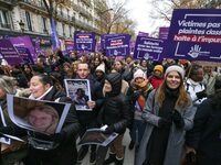 Demonstrators hold placards as they participate in a protest to condemn violence against women, organized by feminist organizations, in Pari...