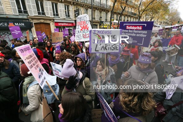 Demonstrators hold placards as they participate in a protest to condemn violence against women, organized by feminist organizations, in Pari...