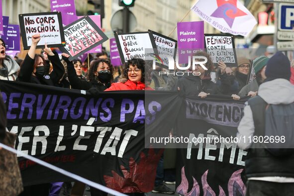 Demonstrators hold a banner as they participate in a protest to condemn violence against women, organized by feminist organizations two days...