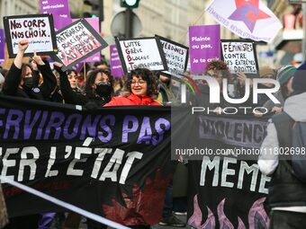 Demonstrators hold a banner as they participate in a protest to condemn violence against women, organized by feminist organizations two days...