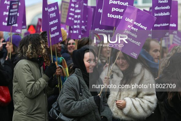 Demonstrators hold placards as they participate in a protest to condemn violence against women, organized by feminist organizations, in Pari...