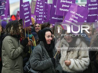 Demonstrators hold placards as they participate in a protest to condemn violence against women, organized by feminist organizations, in Pari...