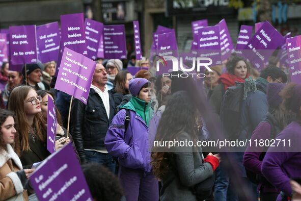 Demonstrators hold placards as they participate in a protest to condemn violence against women, organized by feminist organizations, in Pari...