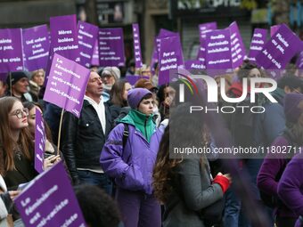 Demonstrators hold placards as they participate in a protest to condemn violence against women, organized by feminist organizations, in Pari...