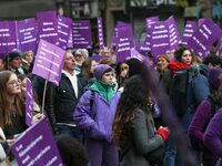 Demonstrators hold placards as they participate in a protest to condemn violence against women, organized by feminist organizations, in Pari...