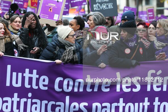 French workers union CGT general secretary Sophie Binet holds a banner as they participate in a protest to condemn violence against women, c...