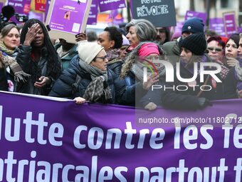 French workers union CGT general secretary Sophie Binet holds a banner as they participate in a protest to condemn violence against women, c...