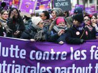 French workers union CGT general secretary Sophie Binet holds a banner as they participate in a protest to condemn violence against women, c...