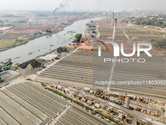 An aerial view shows several brick factories lining the riverbanks near Munshiganj township in Munshiganj, Bangladesh, on November 23, 2024....