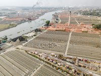 An aerial view shows several brick factories lining the riverbanks near Munshiganj township in Munshiganj, Bangladesh, on November 23, 2024....